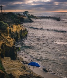 THE CHILDRENS POOL WITH THE ROCKY COASTLINE AND SMALL SAND BEACH OFF OF LA JOLLA CALIFORNIA NEAR SAN DIEGO