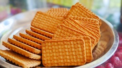 Wheat biscuits in the steel plate with blury background. Indian biscuits popularly known as Chai-biscuit in India