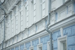 Full-color horizontal photo. Elements of the facade of a historical building. Architecture in the classical style. In shades of blue.