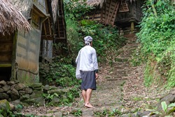 Rangkasbitung-Indonesia, 19-02-2021: Baduy tribe man are doing their activities is front of the traditional Baduy house.