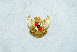 Hand holding Garuda Pancasila emblem Isolated on white background. Indonesia independence day 17th August, pancasila day concept. 