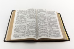 A photo of an open Bible isolated on a white background.