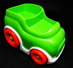 green toy car on black background             