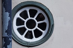 an old round window with white spokes 