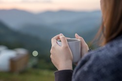 solo woman drink coffee with relax and wellbeing feel with mountain background