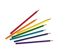 wooden color pencils arranged in bulk on a white isolated background