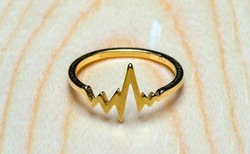 heartbeat ring on wooden background