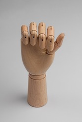 wooden hand with bent fingers into a fist on a white background