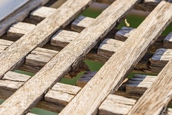 Closeup detail of an weathered damaged wooden gangway.