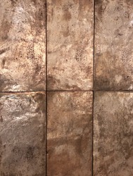 Closeup image of reflective surface of antique textured copper tile background in rectangular shape and rustic style. 
