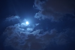 The beautiful night sky with the round moon and cloudy sky