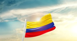 Colombia national flag waving in beautiful clouds.