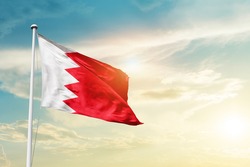Bahrain national flag waving in beautiful clouds.
