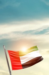United Arab Emirates national flag waving in beautiful clouds.