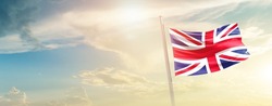 United Kingdom national flag waving in beautiful sky.