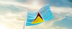 Saint Lucia national flag waving in beautiful sky.