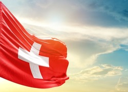 Switzerland national flag waving in beautiful sky.