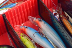 Colorful Fishing Lures on plastic box  desk different fishing baits The fishing equipment.