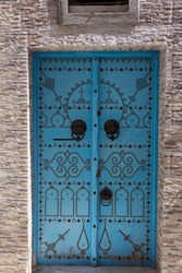 Entrance with blue traditional  doors in Tunis, Tunisia. 