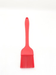 Red spoon brush spatula used for baking isolated on white background