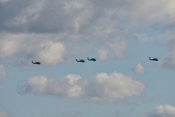 military helicopters flying in formation