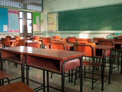 Emphasize primary level blur with no students, no children or teachers with chairs and desks only.