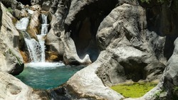 Small waterfall with a natural pool inside the mountains