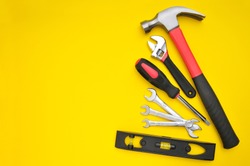Group of various tools on yellow background with space for texts