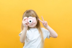 real happiness. hobby or career. beginner photographer with a camera. childhood. girl takes a picture. kid uses digital camera. happy baby photography. photography school