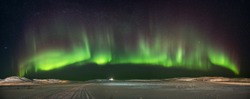 Landscape with northern lights  on the coast of the Barents Sea on the Kola Peninsula at night at high ISO sensitivity. Panoramic view