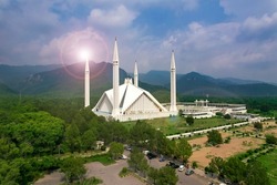 Aerial shot of Islamabad, the capital city of Pakistan showing the landmark Shah Faisal Mosque and the lush green mountains of Margala Hills
