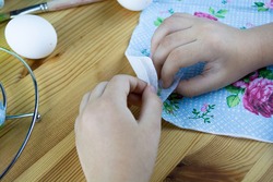 Decorating Easter eggs with decoupage technique. Hands peel off the napkin layer. Step by step, tutorial. Step 1