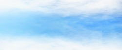 Soft blue sky and blurred fade white clouds at top and bottom side for natural background design.