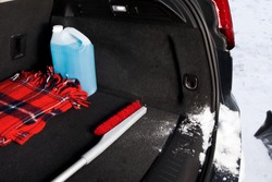 winter driving safety - a snow brush and ice scraper in the trunk