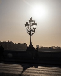 A backlit lamp post in the morning 