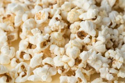 Popcorn grains close-up, close popcorn texture, popcorn on a yellow background