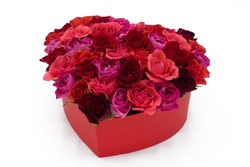 Heart of colorful red roses in a box on white background.