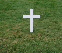 White cross grave maker standing alone in Arlington National Cemetery