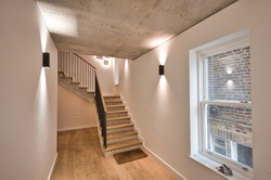 Contemporary Apartment interior design with concrete ceiling and wood flooring stairs London UK
