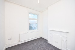 Old Victorian House Bedroom Refurbished with Grey Carpet and Flash White Painted Walls - Unfurnished Empty Room in London UK 