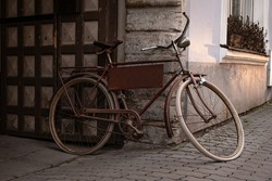 Retro bicycle with house on the background. Old, cool, stylish, vintage, rusty bike. Beautiful, scenic, oldfashion, monochrome, artistic film grain. Summer vibe. Ecological, hipster transportation