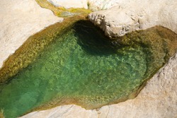 Hot and sunny day in a clear turquoise Natural pools of  Ein Gedi, David river.
National park. West of the Dead Sea area.Israel.One of the most popular nature site in the country