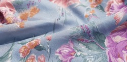 Light blue fabric with pink, red, green floral print; in folds (texture).
