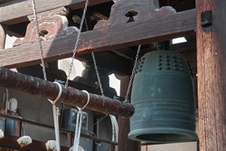 Bonsho (The Buddhist bell) hanging at the bell tower with the beam suspended on ropes in the Buddhist temple of Kyoto. Japan