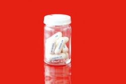 Medication antiviral capsule pills in a medicine bottle for treatment infection to prevention and treatment for coronavirus infection COVID-19, drug nCCoV 2019. Pandemic infectious concept