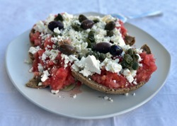 Dakos (Ntakos) traditional Greek starter common in Crete. Dried bread with tomato feta, oregano, paprika and olive oil