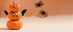Halloween banner. Decoration for Halloween party - cute pumpkins with eyes and funny faces. Set pumpkin monsters and crawling spiders. Copy space, art activity for kids, diy master class, promotion