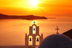 Santorini with Firostefani Church against sunset over sea, Fira, Greece