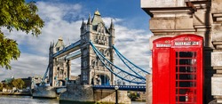 Tower Bridge with red phone booths in London, England, UK