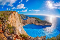Navagio beach with shipwreck against sunset on Zakynthos island in Greece